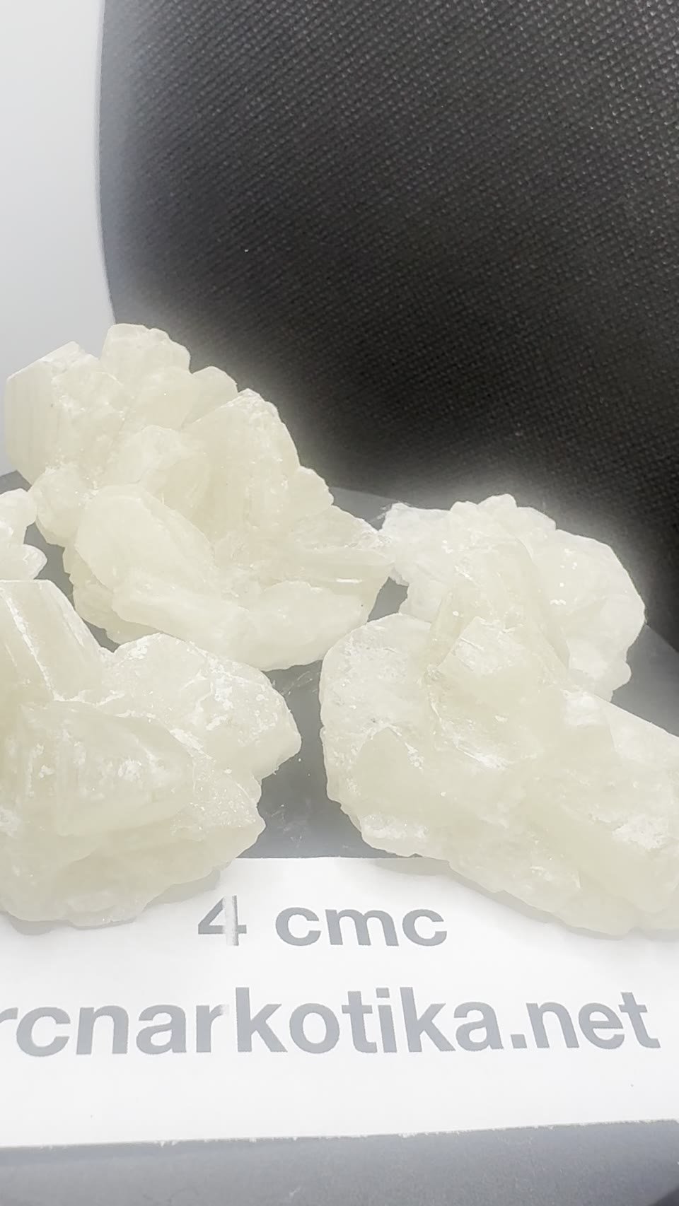 4-CMC crystals with a batch card.